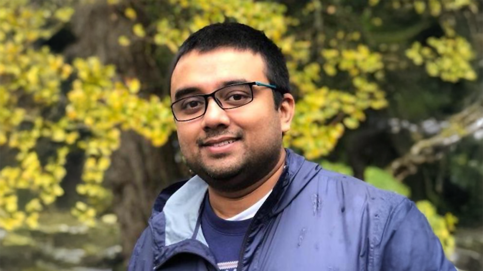 A color photo of Tapomayukh Bhattacharjee, a man with glasses, short dark hair and gray jacket