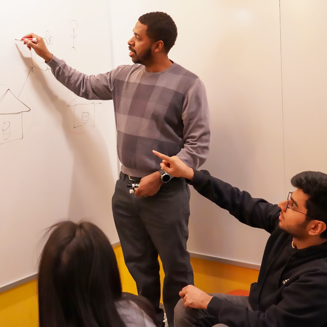 Weatherspoon, Abid and Lei sketch out a diagram of the data platform. Photo by Jackie Swift.