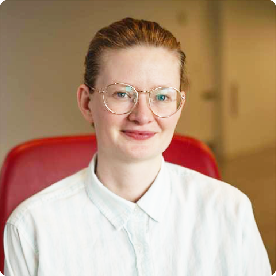 A color photo of a woman smiling for a portrait.