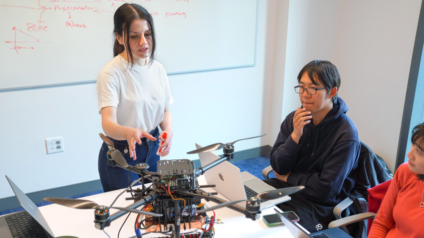 Mehrnaz Sabet, a doctoral student in the field of information science, leads a work session with graduate students assisting with Project Orion, an autonomous airspace coordination system she’s developing at Cornell.