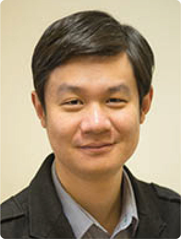 A color photo of a man smiling for a photo.