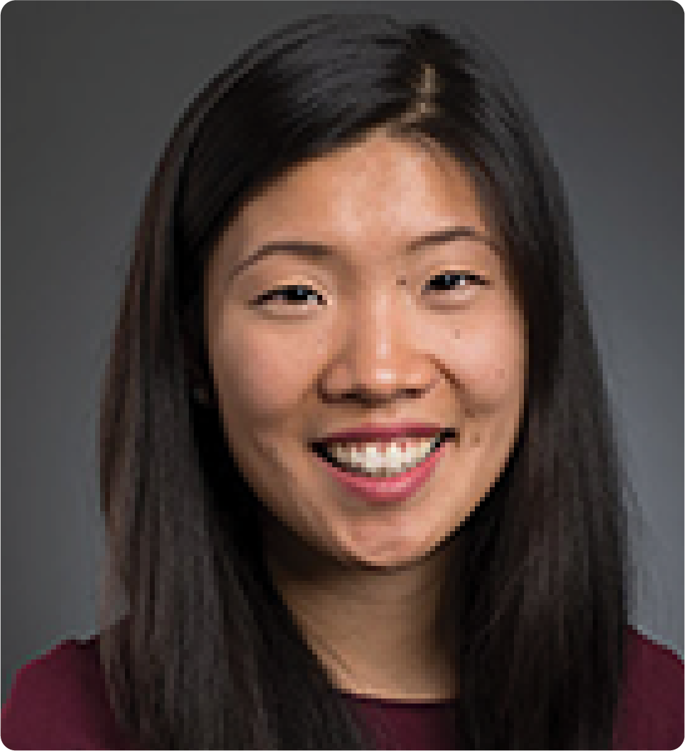 A color photo of a woman smiling for a photo.