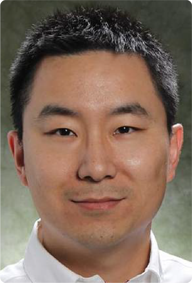 A color photo of a man smiling for a photo.