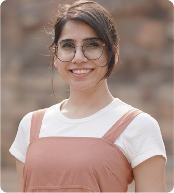 A color photo of a woman smiling for a photo.