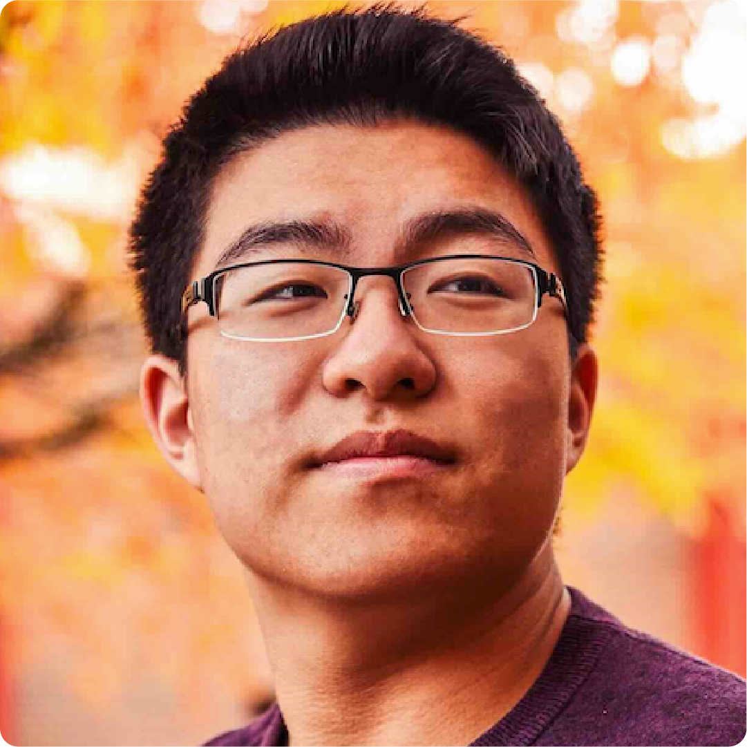 A color photo of a man with glasses.