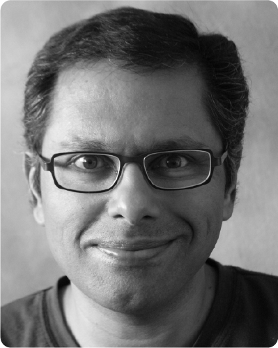 A black and white photo of a man with glasses.