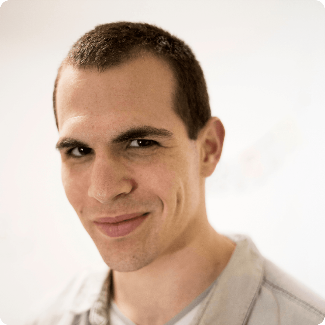 A color photo of a man smiling for a photo.