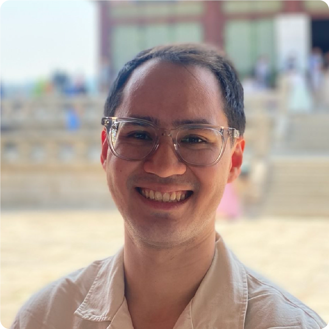 A color photo of a man smiling for a photo.