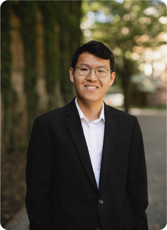 A color photo of a man with glasses.