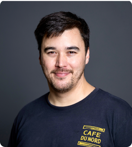 A color photo of a man smiling for a photo.