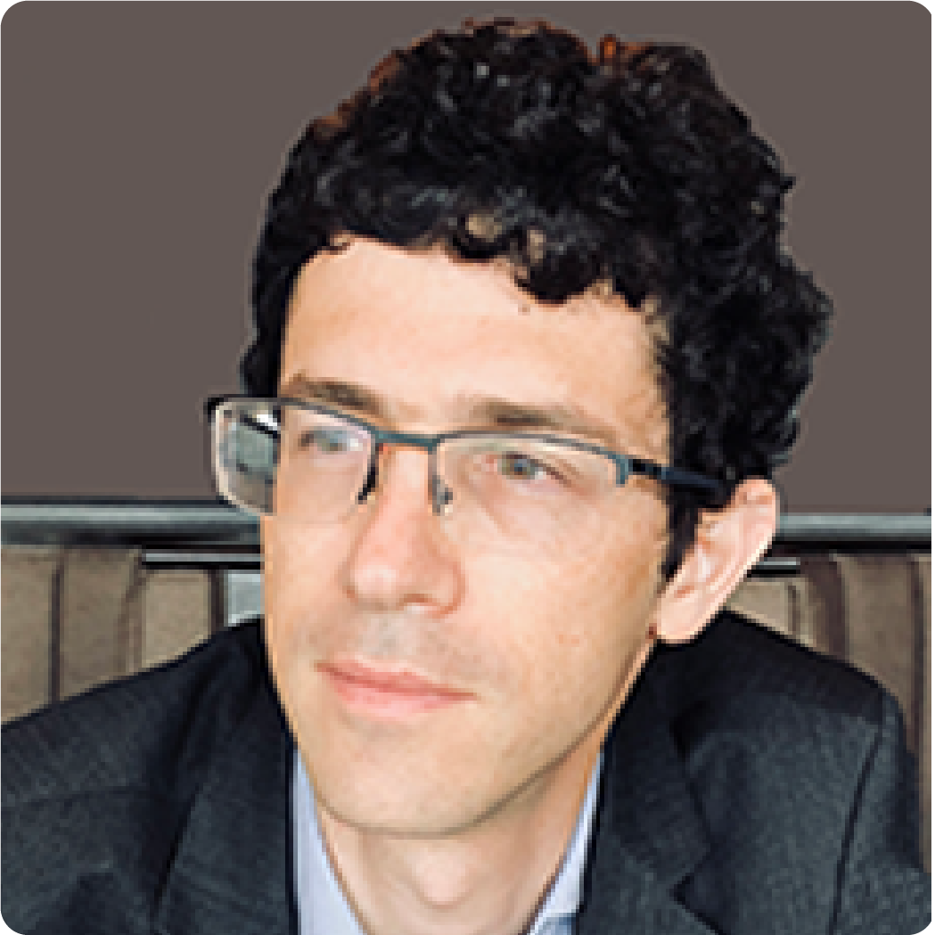 A color photo of a man with glasses.