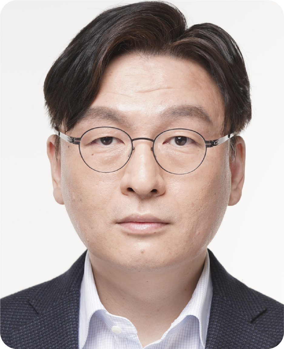 A color photo of a man with glasses.