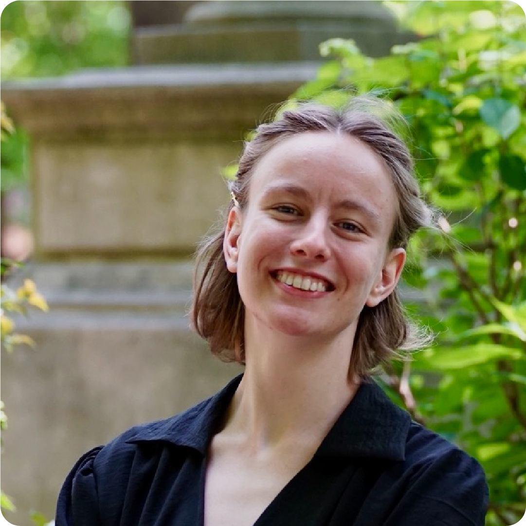 A color photo of a person smiling for a photo.