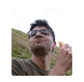 A color photo of a man with glasses.