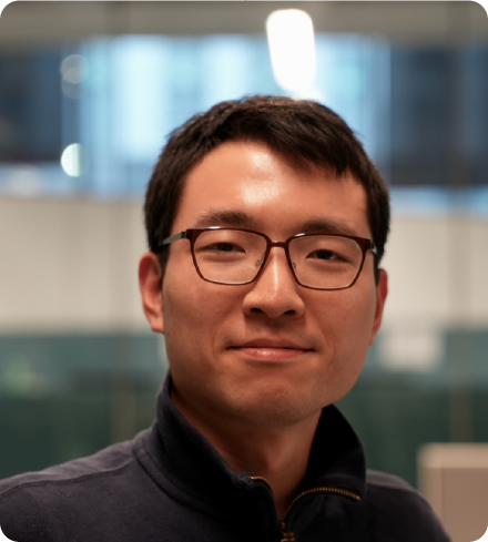 A color photo of a man with glasses.
