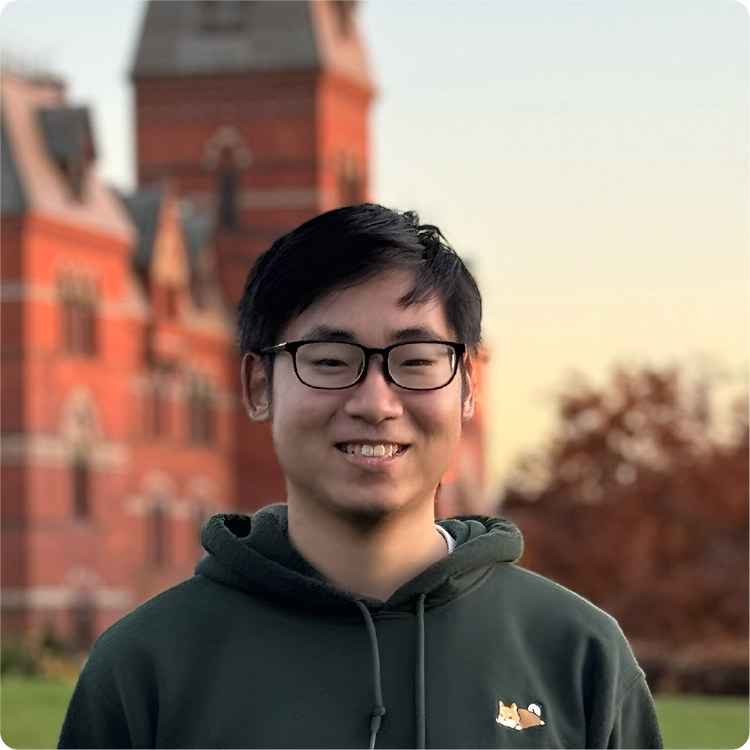 A color photo of a man with glasses smiling for a photo outside on Cornell's Ithaca campus.