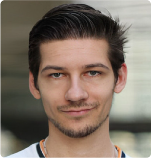 A color photo of a man smiling for a photo.