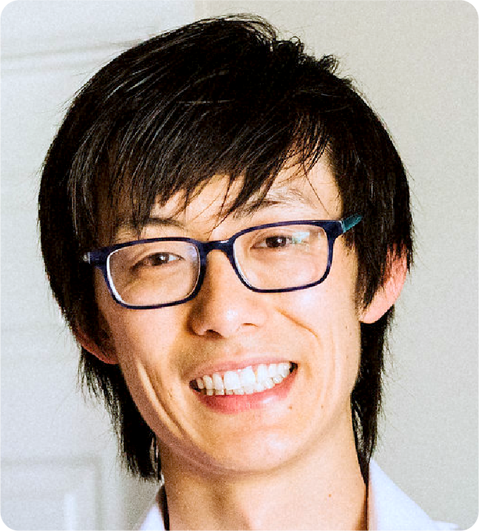 A color photo of a man smiling for a photo.