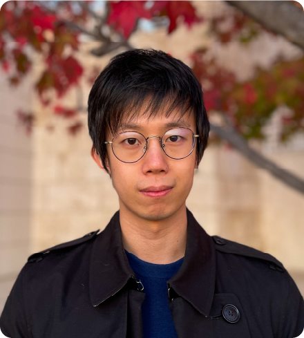 A color photo of a man with glasses.
