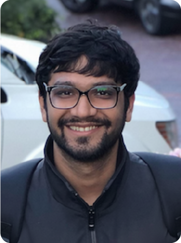 A color photo of a man smiling for a photo.