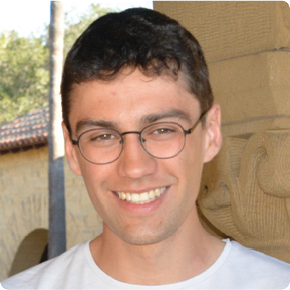 A color photo of a man with glasses, smiling for a photo.