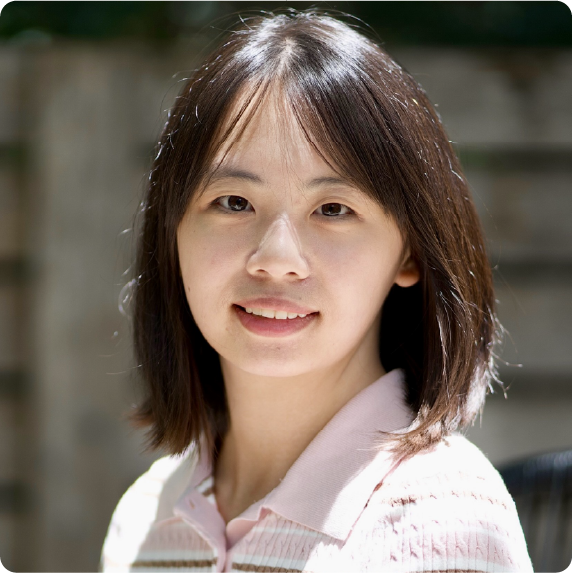 A color photo of a woman smiling for a photo.