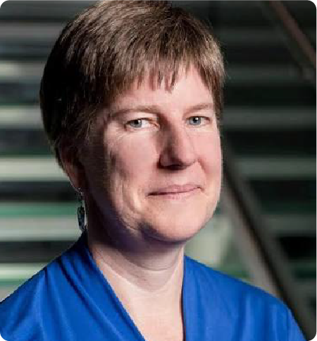 A color photo of a woman in a blue shirt.