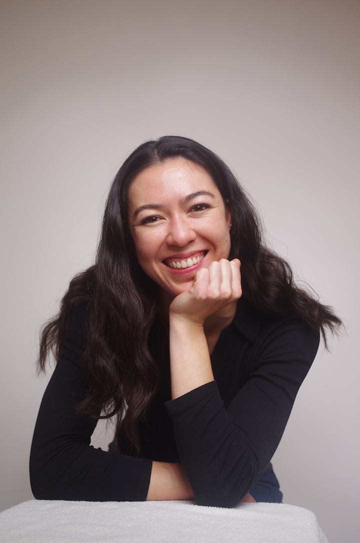 A color photo of a woman smiling for a portrait.
