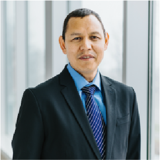 A color photo of a man in a suit.