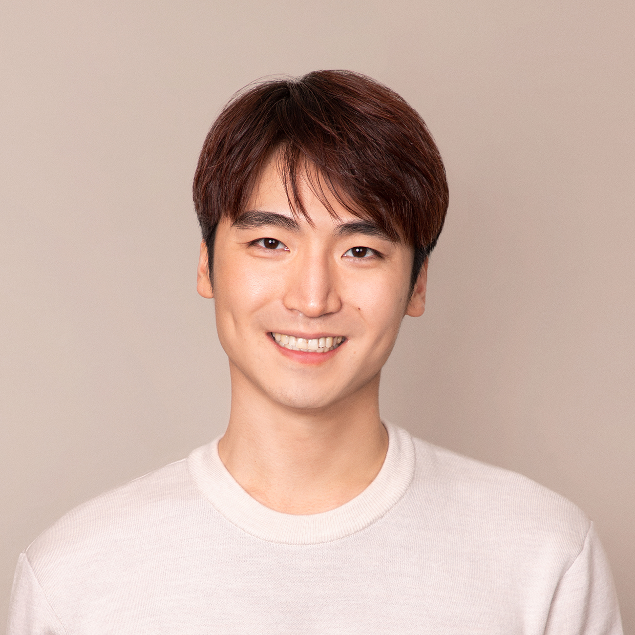 A color photo of a man smiling for a photo.