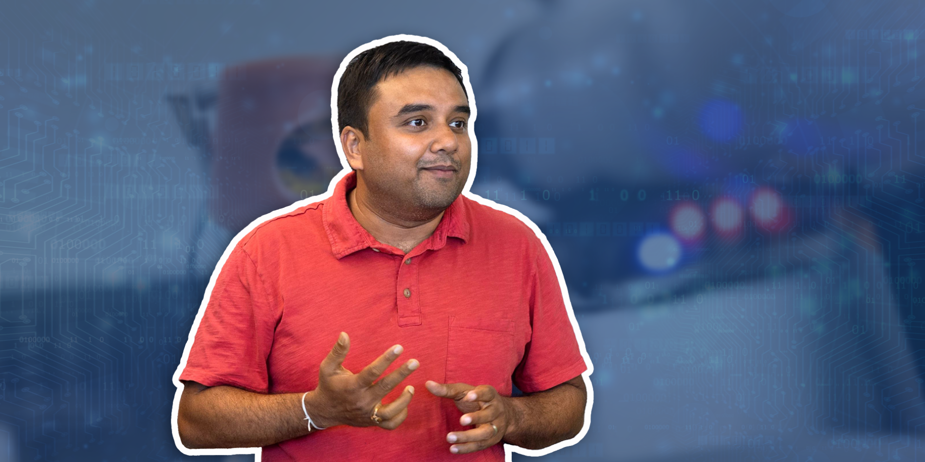 A color photo showing a man wearing a red shirt.