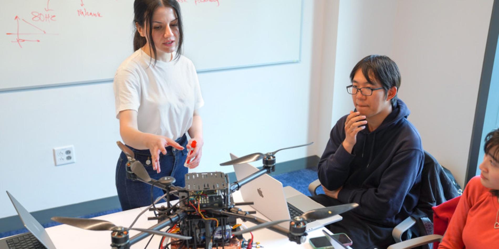 Mehrnaz Sabet, a doctoral student in the field of information science, leads a work session with graduate students assisting with Project Orion, an autonomous airspace coordination system she’s developing at Cornell.