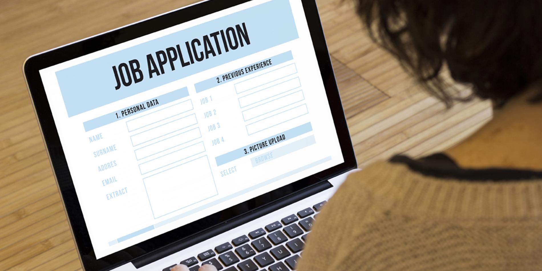 Person views a laptop screen that displays "Job Application"