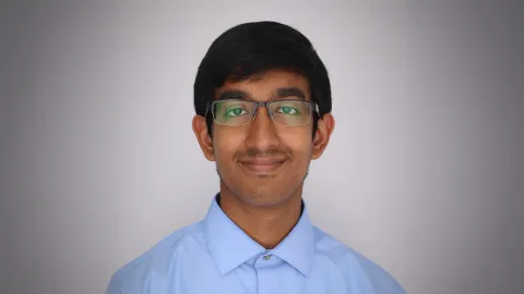 A color photo of a man smiling for a photo.