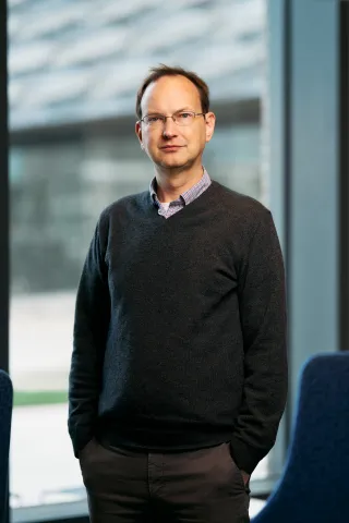 David Mimno stands in front of a window at Gates Gall