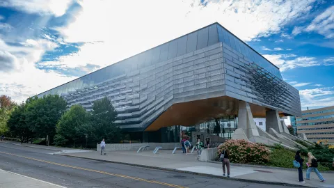 South view of Gates Hall (showing fins) on a sunny day.