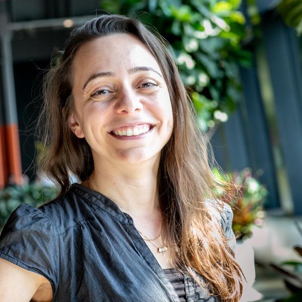 a white woman with long brown hair smiles 
