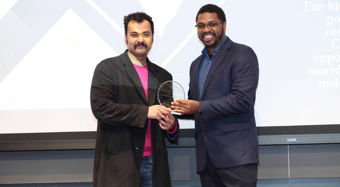A color photo of 2 men.