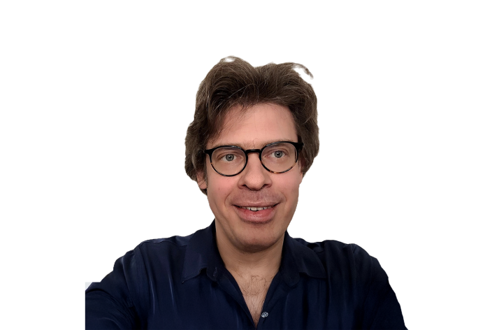 A photo of Immanuel Trummer, a man with brown hair, glasses, in front of a white background