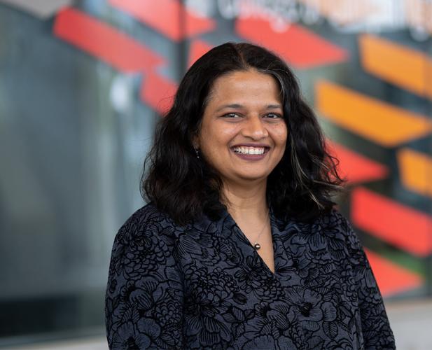 Professor Kavita Bala, smiling headshot, a woman with dark hair in a black shirt.