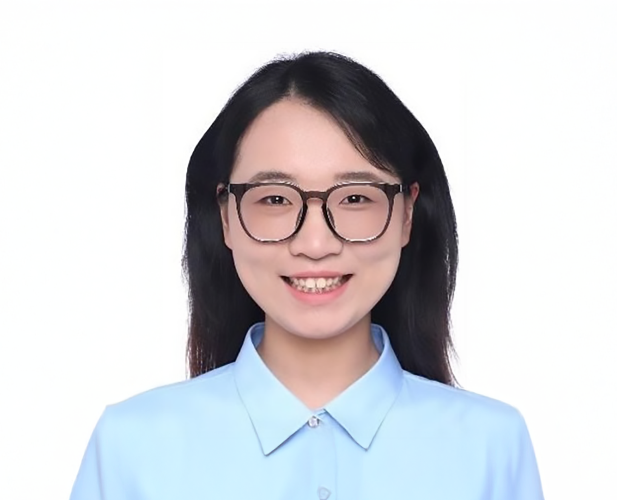 A color photo of a woman smiling for a photo.
