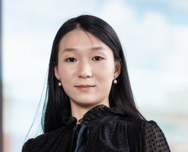 Woman in black shirt, looking at camera