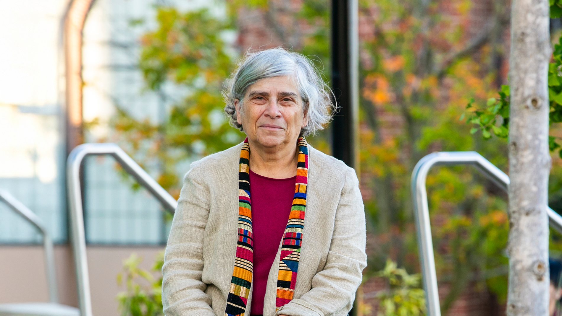 A color photo of Susan Landau sitting outside.